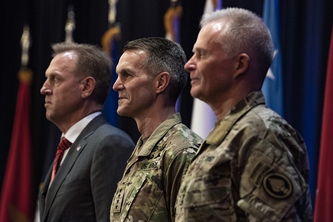 U.S. Army Gen. Richard D. Clarke, center, takes command of the U.S. Special Operations Command from U.S. Army Gen. Raymond A. Thomas III, right, during a ceremony in Tampa, Fla., on March 29, 2019